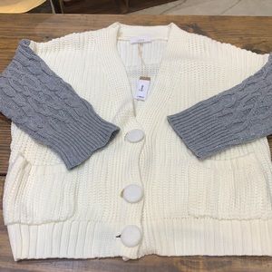 New small/medium Lucca cardigan. Cream with gray sleeves and 2 pockets.